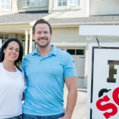 New homeowners in front of house